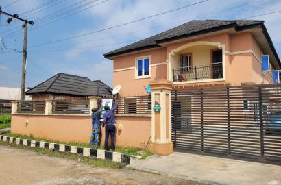 2 units of a story building consist of 3-bedroom flat up and a 2-bedroom down at the front and a 2-bedroom up, 2-bedroom down at the back on a corner-piece land