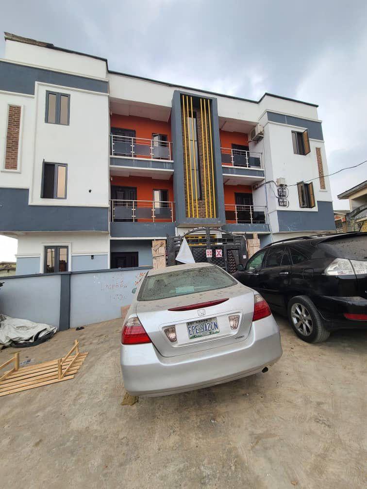 A unit of relatively new (just a year old) 2 bedroom up (1st floor) flat both rooms ensuite, with guest toilet, all tiled  with POP and kitchen cabinet, 6 occupants to share compound